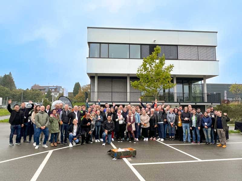 The IHSE team, a business specializing in KVM solutions, gathered in front of their office building for a group photo.