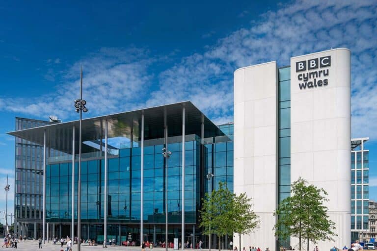 Exterior view of NBC Studios building with a clear blue sky in the background.