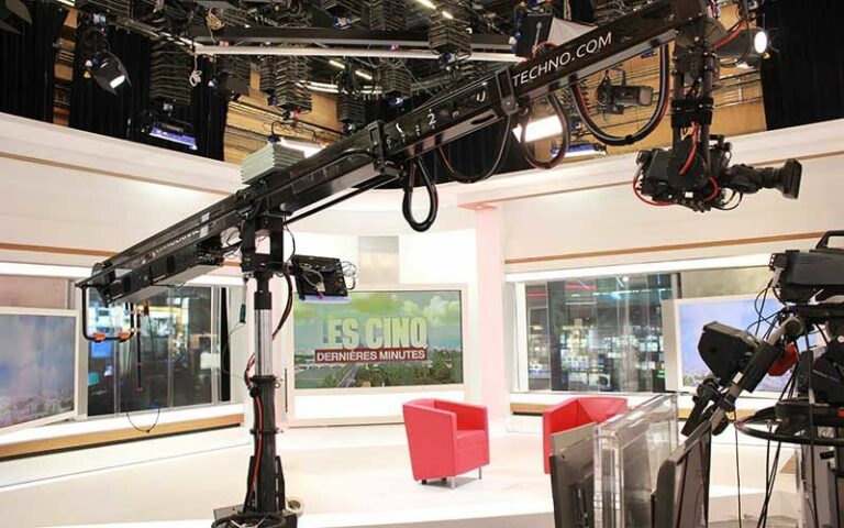Close-up of studio equipment, including microphones and audio mixers, in a well-lit indoor studio.
