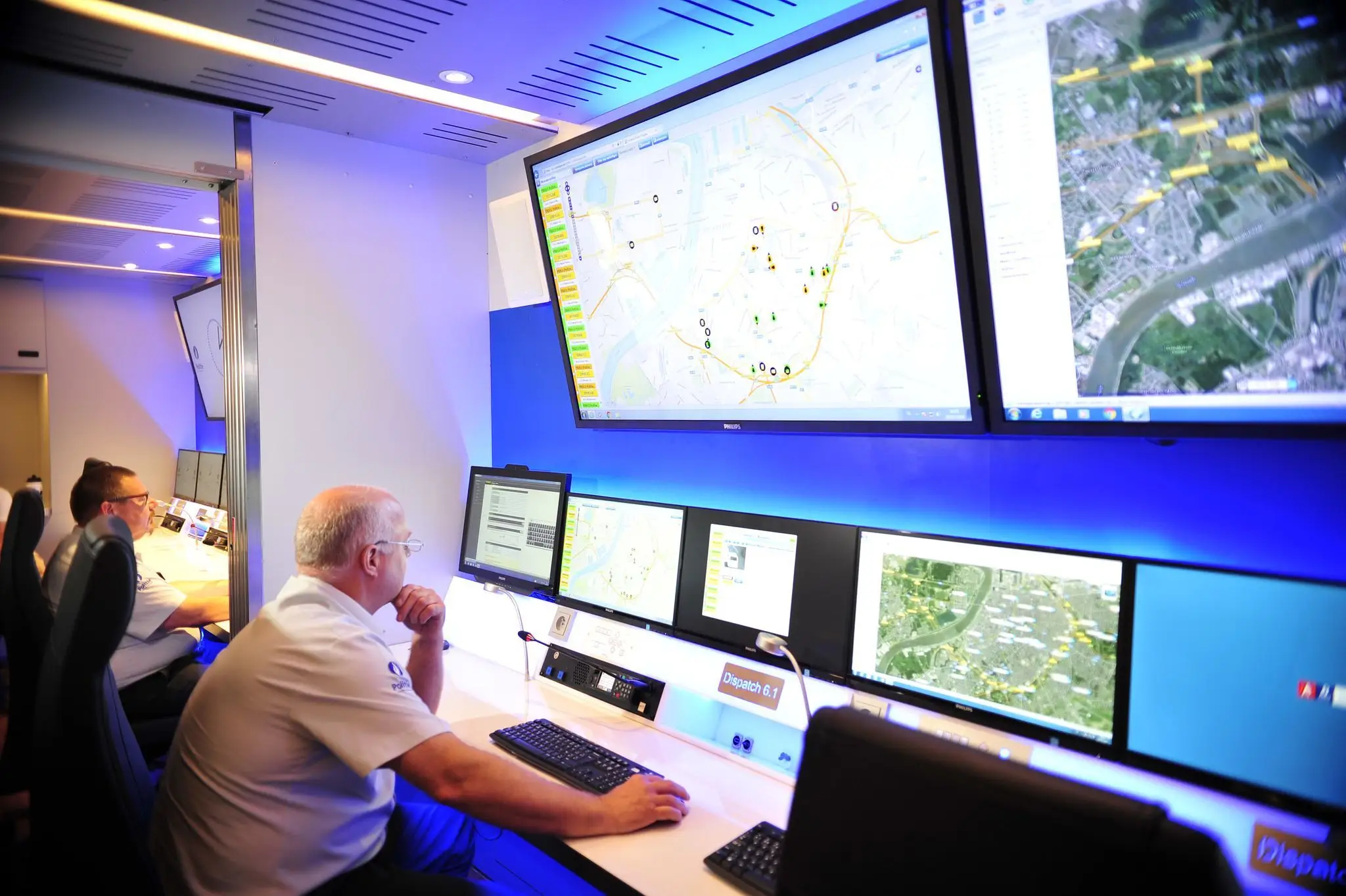 IT professionals monitoring secure networks and infrastructure from a centralized operations room using KVM systems.